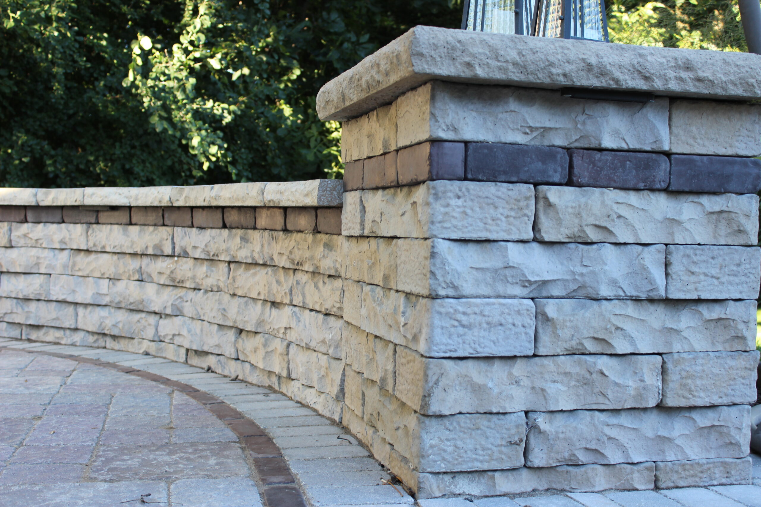 Claremont Walls have the ability to curve which gives you the ability to make the wall of your dreams in a snap. Other products shown: Dimensional Coping and 34" Column Cap